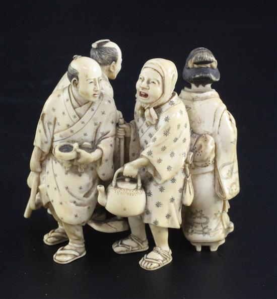 A good Japanese ivory okimono of five street pedlars or performers, signed Ikkosai, Meiji period, height 6.2cm
